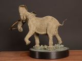 a statue of an elephant on a wooden table