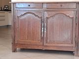 a wooden cabinet with a mirror on top of it