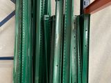 many pieces of green metal on a shelf in a warehouse