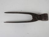 a small metal tool that is laying on a white surface