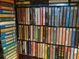 a lot of dvds on a shelf in a room