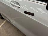 a white car with a sticker on the side of it
