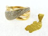 two gold rings and a pendant on a white surface
