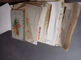 a pile of old letters and envelopes on a table