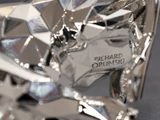 a close up of a shiny motorcycle with a name tag on it