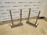 two metal racks are sitting on the floor in front of a wall