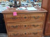 a dresser with a mirror on top of it in a room