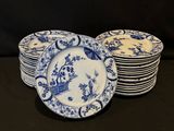 several blue and white plates are stacked on top of each other