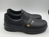 a close up of a pair of black shoes on a white surface