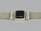 a close up of an apple watch with a metal band