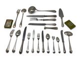 many different types of silverware on a white surface