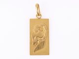 une image représentant un pendentif en or orné d'un visage de femme