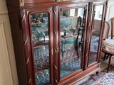 a glass cabinet with a lot of glasses on top of it
