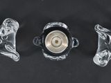 three pieces of glass sitting on top of a table next to each other