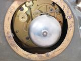a close up of a clock that is on a table