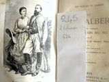un vieux livre sur lequel figure le dessin d'un homme et d'une femme debout l'un à côté de l'autre