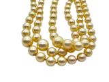 a close up of three strands of pearls on a white background