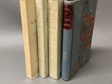 three books are stacked on top of each other on a table