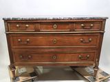 an antique chest of drawers with marble top on casteors