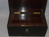 a small wooden box with a key in it