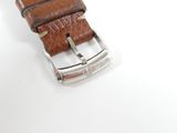 the strap is made of brown leather and has a silver buckle