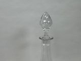 a glass bottle with a glass stopper on top of it