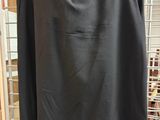 a black skirt hanging on a rack in a store