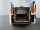 the back of a white van with its doors open in a room