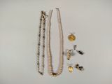 two necklaces, a bracelet, and a ring are laying on a table
