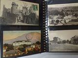 a person holding a book with pictures of a town on it