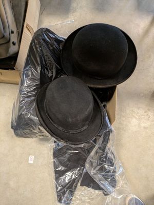 two hats that are sitting in a box on the floor