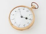 une montre de poche ancienne avec un boîtier en or et des chiffres romains sur le cadran
