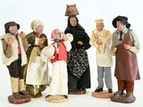 five figurines of people dressed in traditional clothing