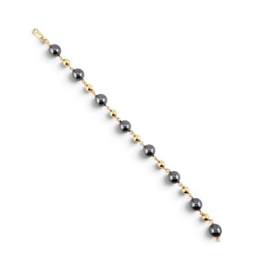 un bracelet en perles noires et dorées sur fond blanc