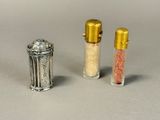 three salt shakers sitting next to each other on a table