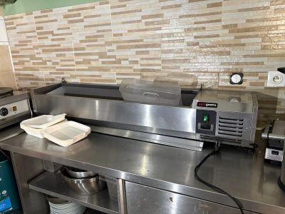 a large stainless steel counter in a commercial kitchen
