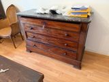 a wooden dresser with a marble top in a living room
