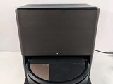 a close up of a black speaker on a stand with a white background