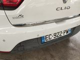 a close up of a white car parked in a garage