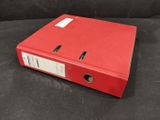 a red binder sitting on top of a black table