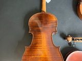 a violin, a violin case, and a violin on a table
