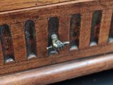a close up of a wooden box with a handle on it