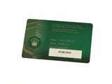 a green credit card with a crown on it