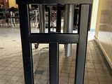 an image of a black speaker on a stand in a room