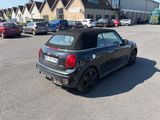 a small black car parked in a parking lot