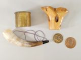 a horn, a pipe, and a coin on a table