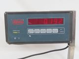 clock on a metal stand displaying the time and date of the day
