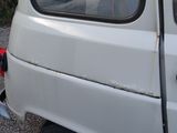 a small white van parked on the side of the road