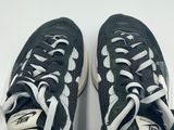 pair of black and white sneakers with white laces on them