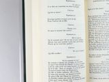 a open book with a green ribbon on it